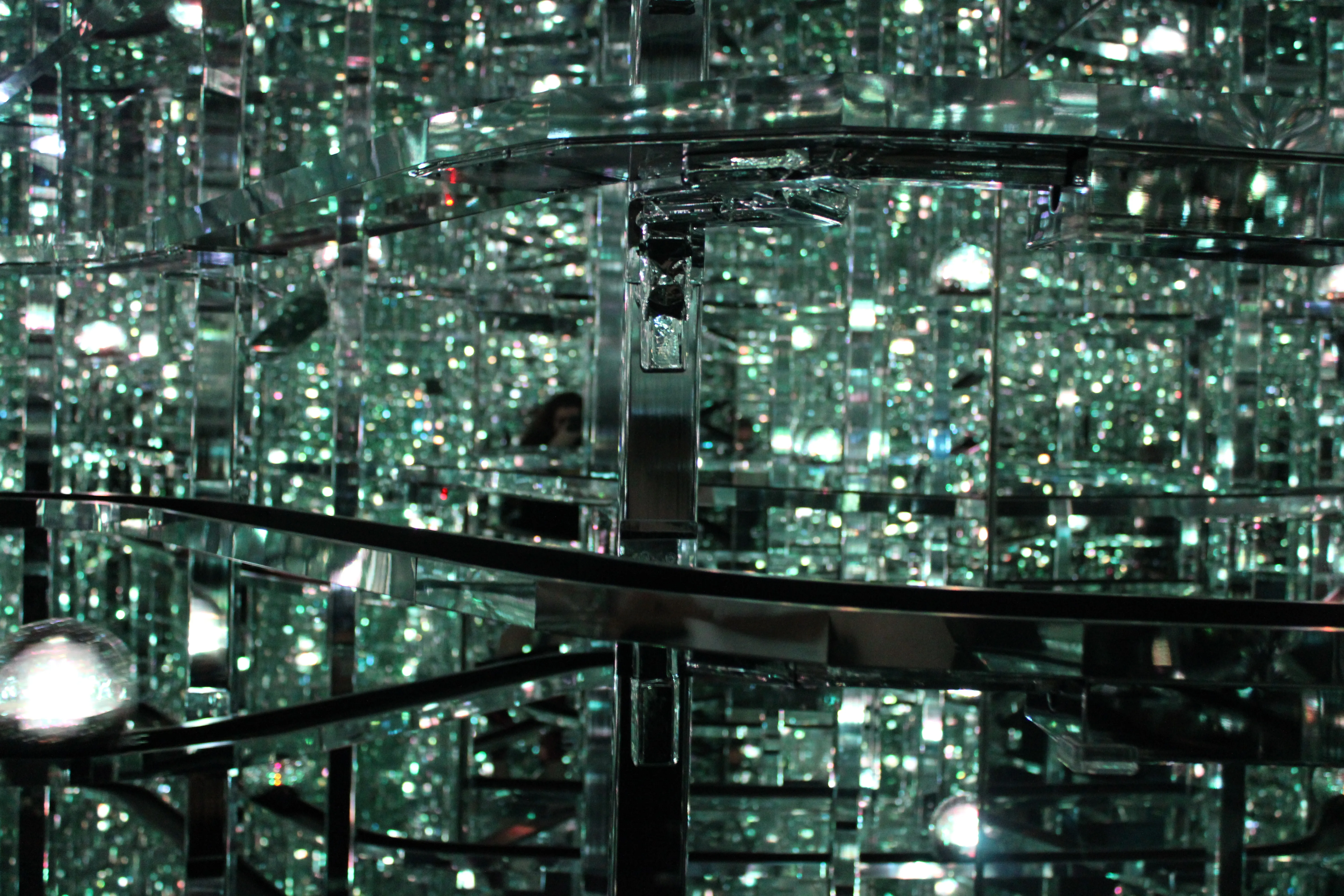 Balls of light going past on tracks, everything vaguely green-ish