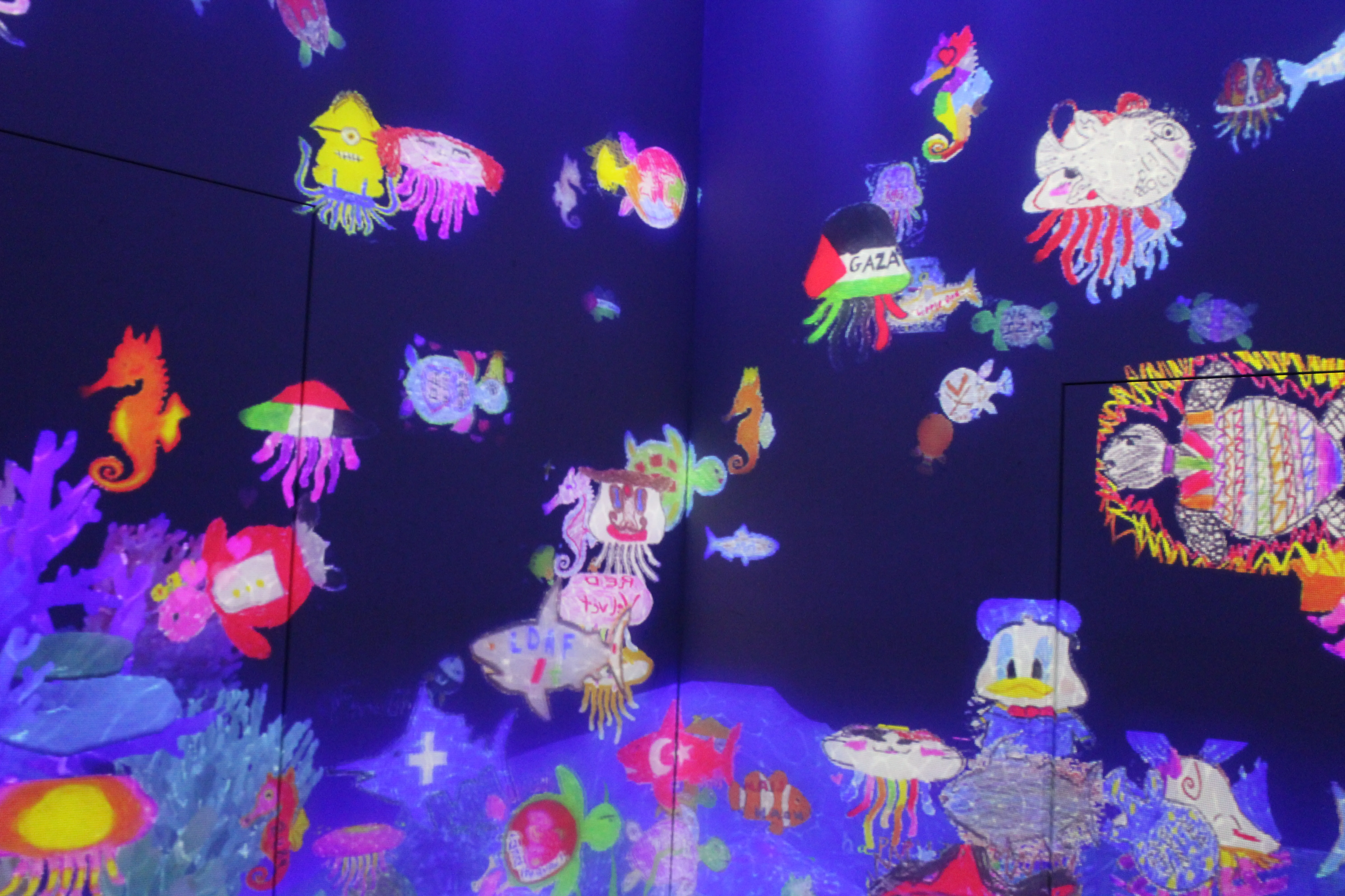 TeamLab&#x27;s fish drawing room where you can draw fish and they appear on the walls. This includes a minion jellyfish and a Gaza jellyfish, which I find humorous